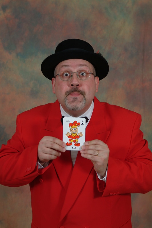 Magician holding a card