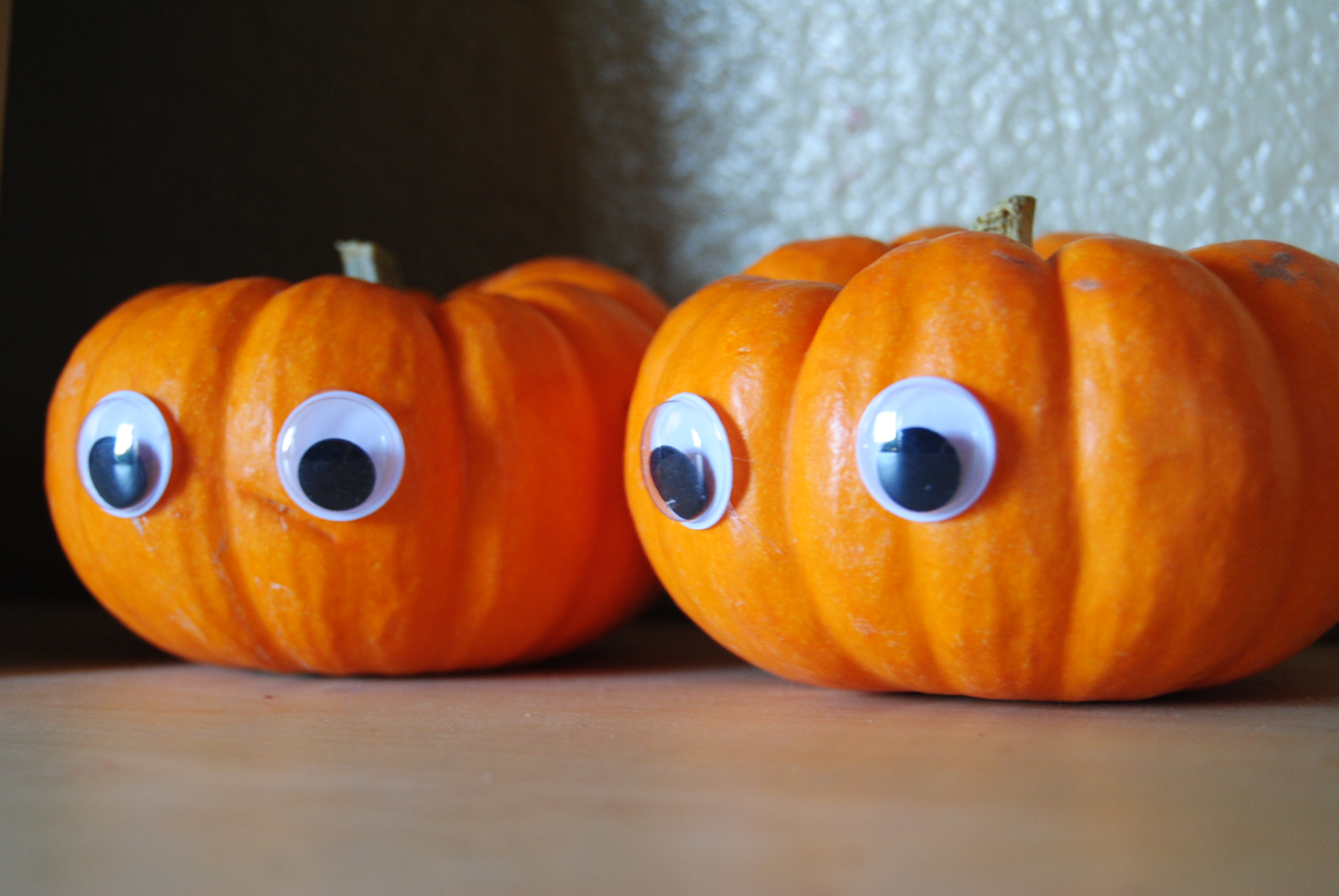 Two pumpins with googly eyes