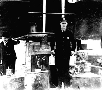 Local police confiscating illegal moonshine.