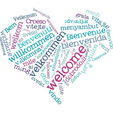 Heart made of the word welcome written in many languages.