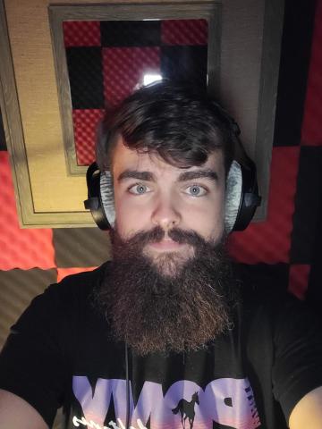 Josh Oster in music studio with headphones