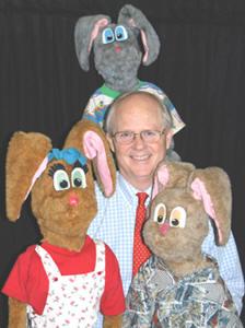 Man surrounded by puppets