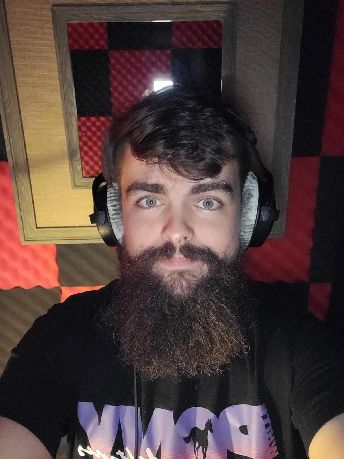 Josh Oster in music studio with headphones